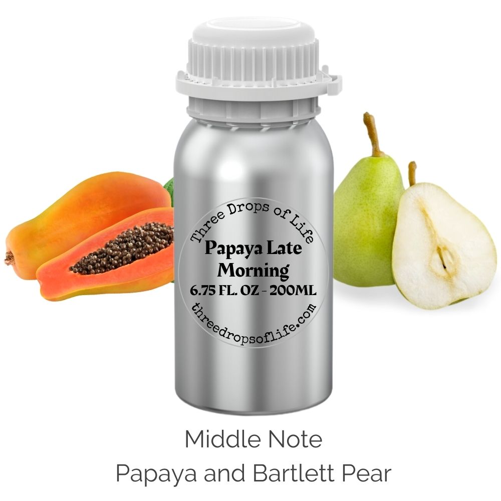 Bottle of 'Three Drops of Life Papaya Late Morning' with papaya and Bartlett pear on a white background