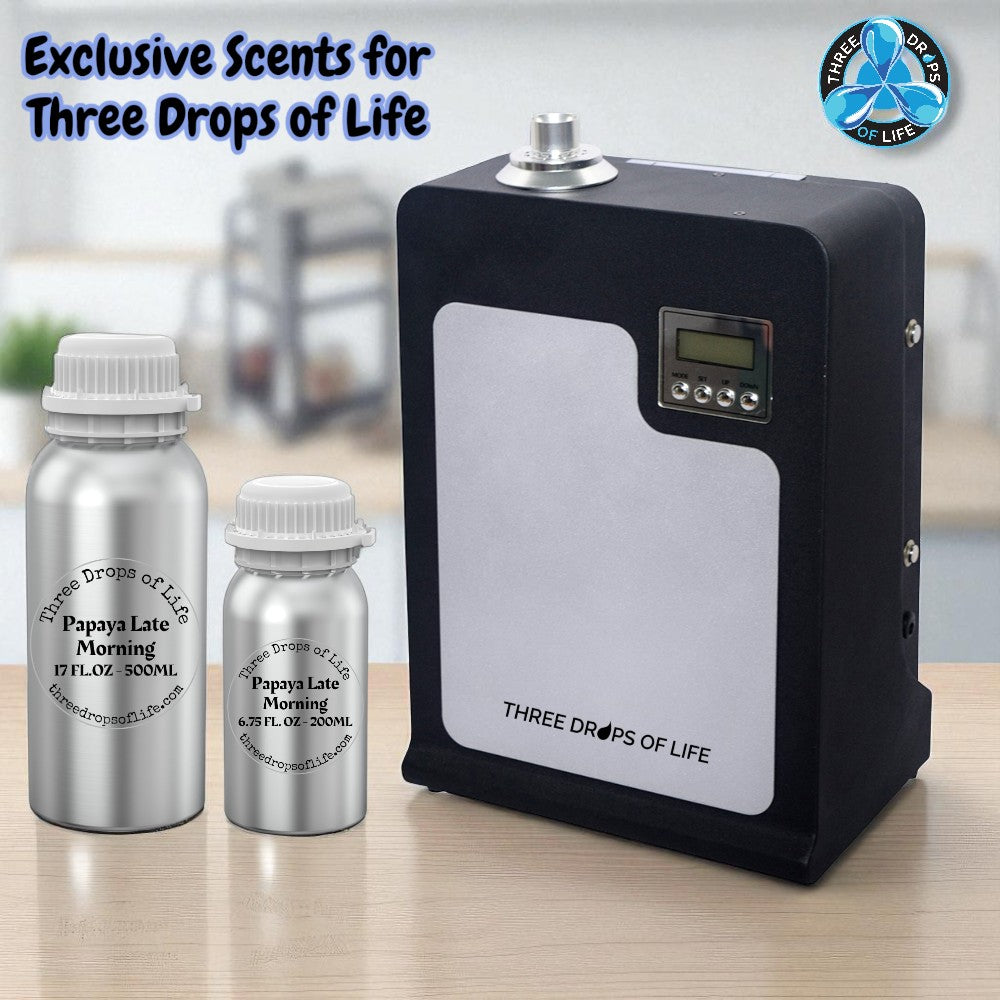 Three Drops of Life diffuser and bottles on a wooden surface with a blurred background